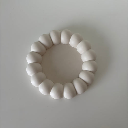 A white jesmonite tray, rounded segmented design, displayed on a neutral light gray background.