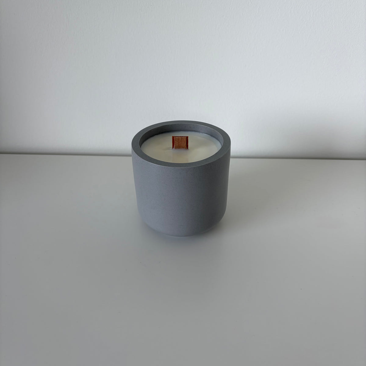 Bare Forest Walk candle in an anthracite grey jesmonite pot with wooden wick, handmade in Switzerland.
