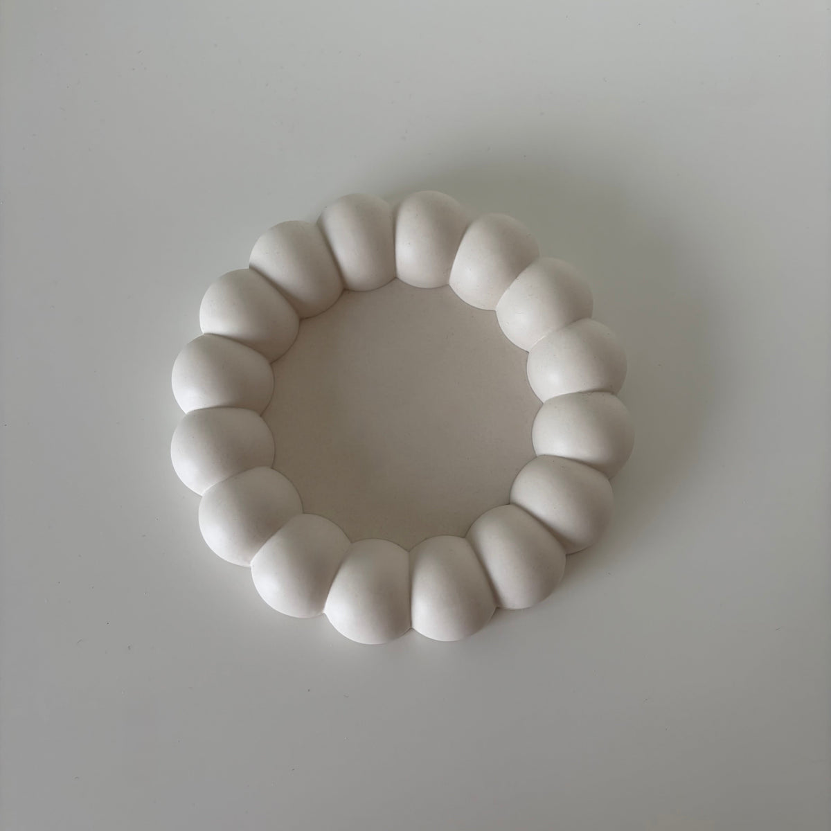 Bloom Tray, round off-white jesmonite tray with a sculptural bubble rim, handmade in Switzerland